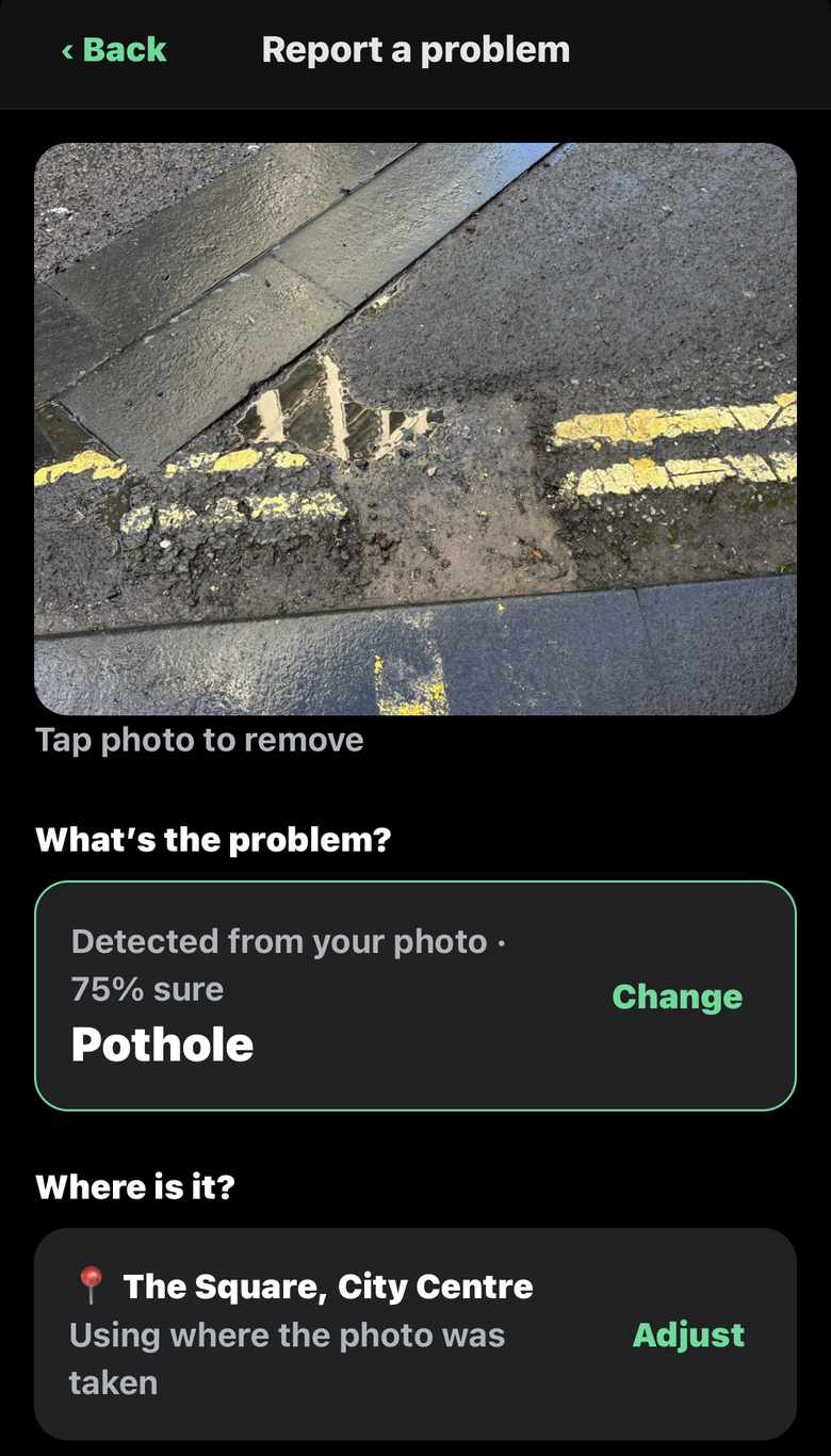 A photo of a water-filled pothole, detected as a pothole with 75% confidence and located from the photo
